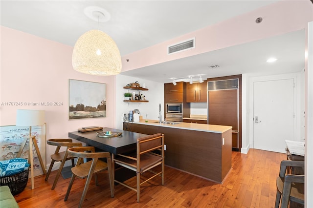 dining area featuring sink and light hardwood / wood-style floors