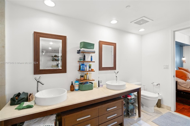 bathroom with tile patterned floors, vanity, and toilet