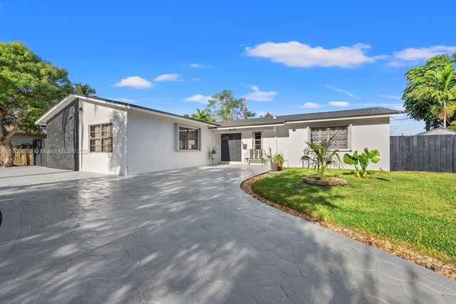 ranch-style house featuring a patio and a front lawn