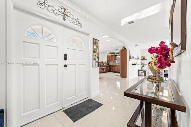 tiled entryway with ornamental molding