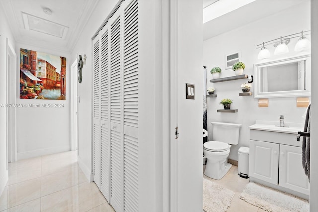 bathroom with tile patterned flooring, vanity, toilet, and ornamental molding