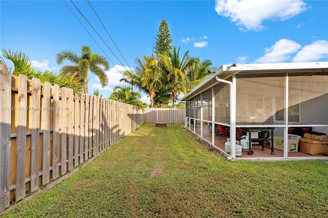 view of yard featuring a sunroom and a patio area