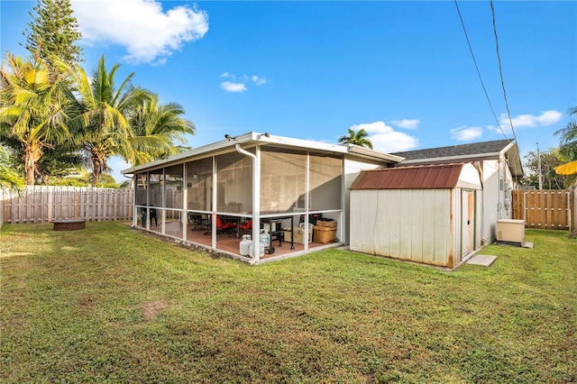 back of house featuring a patio area, a sunroom, and a yard