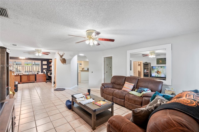 living room with light tile patterned floors and a textured ceiling