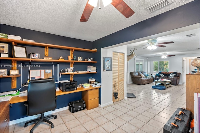 office area with light tile patterned floors, a textured ceiling, and ceiling fan