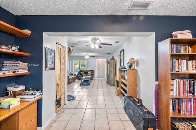 interior space with light tile patterned floors and a textured ceiling