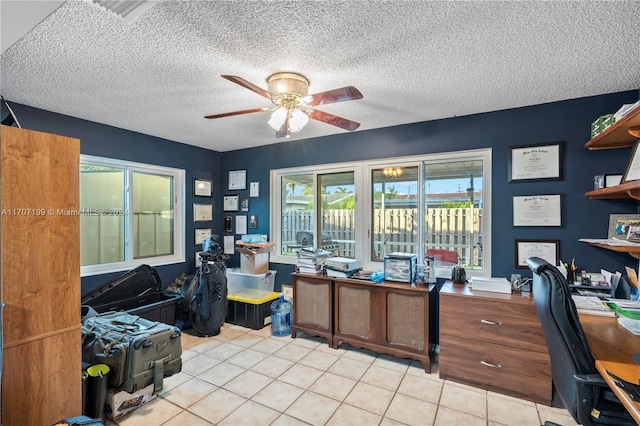 home office featuring ceiling fan, light tile patterned flooring, and a textured ceiling