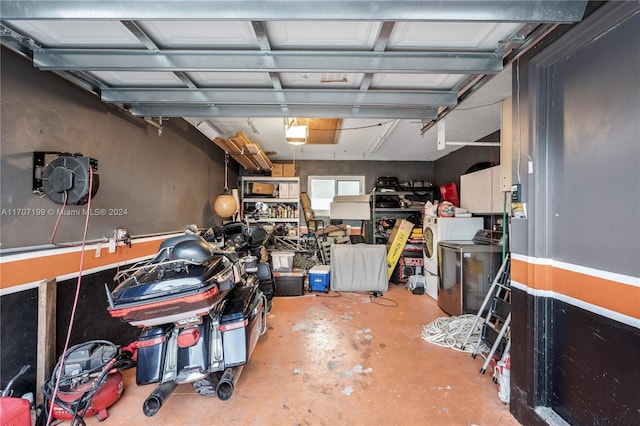 garage featuring a garage door opener and washer / dryer