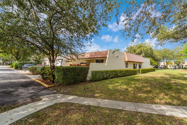 view of property exterior with a lawn