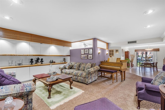 carpeted living room with ceiling fan