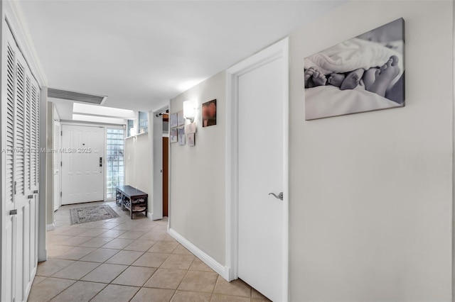 hall featuring light tile patterned floors