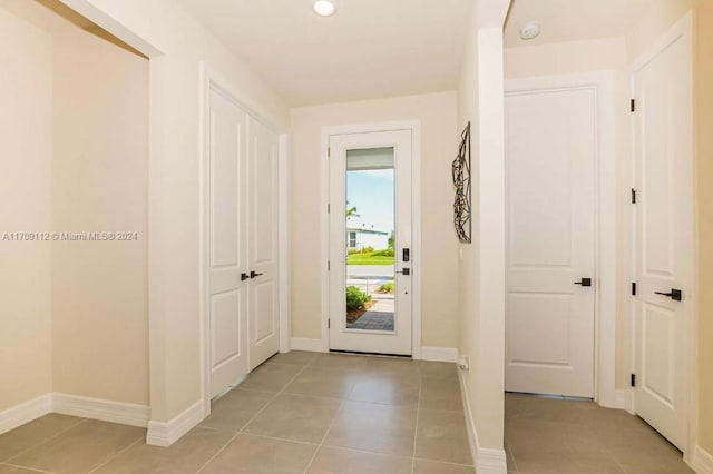 doorway featuring light tile patterned floors