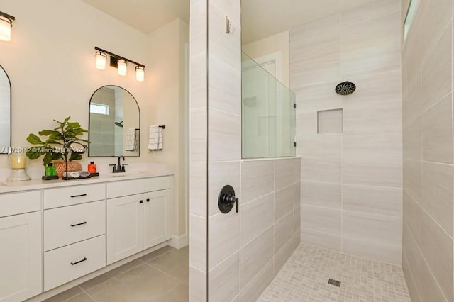 bathroom featuring tile patterned floors, vanity, and tiled shower