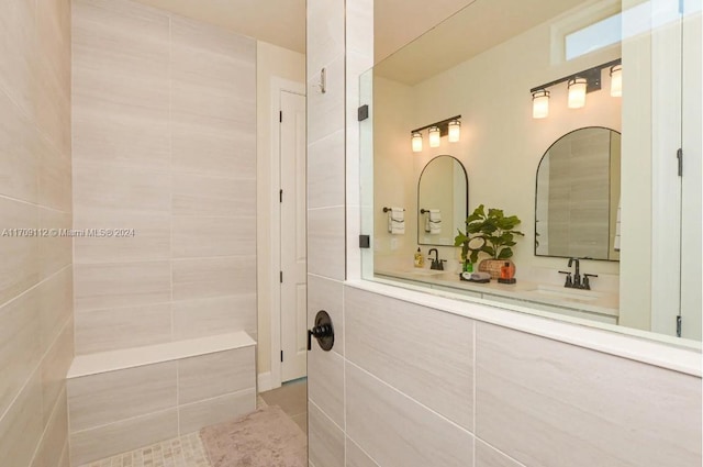 bathroom featuring tile patterned flooring, vanity, and walk in shower