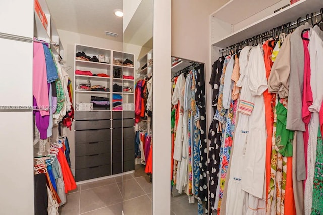 walk in closet featuring tile patterned flooring