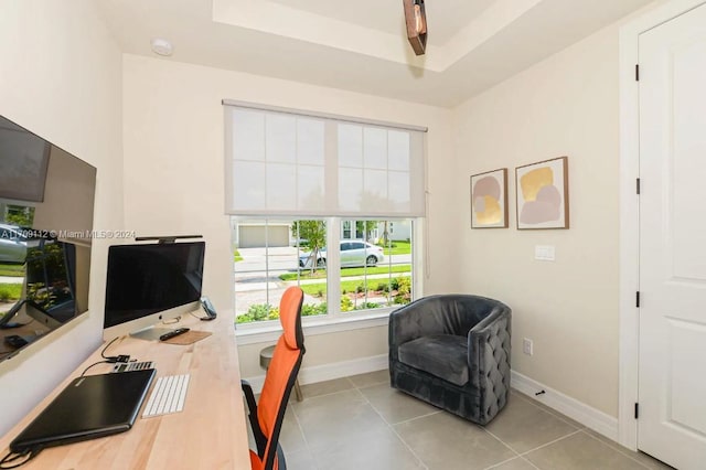 tiled office featuring a raised ceiling