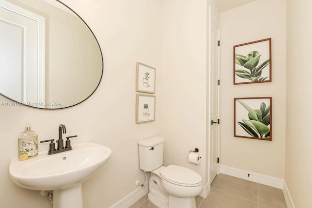 bathroom with tile patterned floors, toilet, and sink