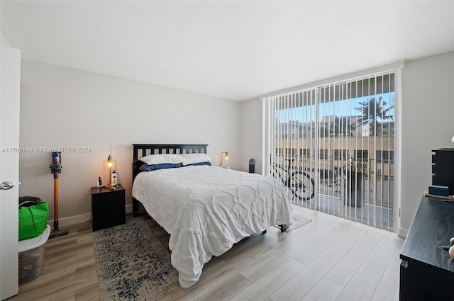 bedroom featuring access to exterior and light hardwood / wood-style floors