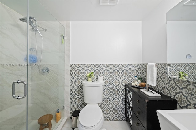 bathroom with a shower with door, toilet, and tile walls