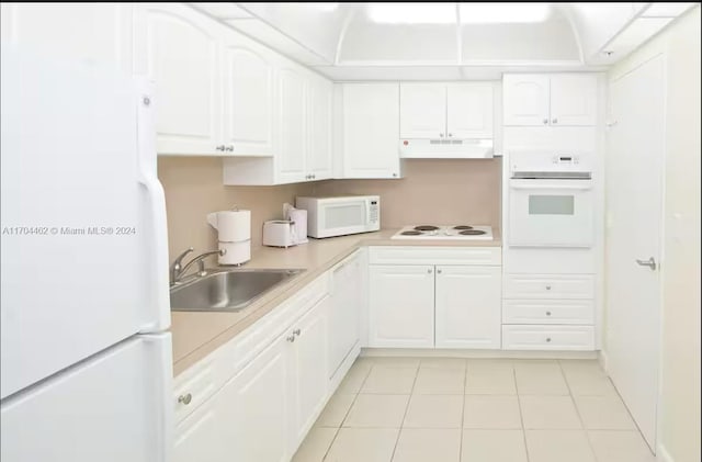 kitchen with sink, white cabinets, white appliances, and light tile patterned floors