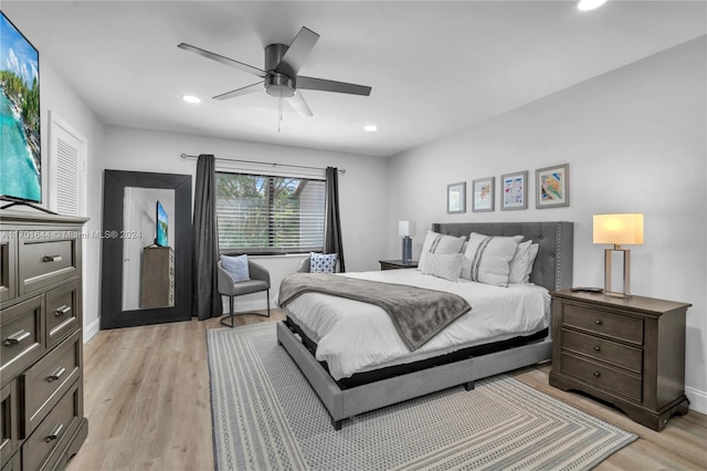 bedroom with ceiling fan and light hardwood / wood-style flooring