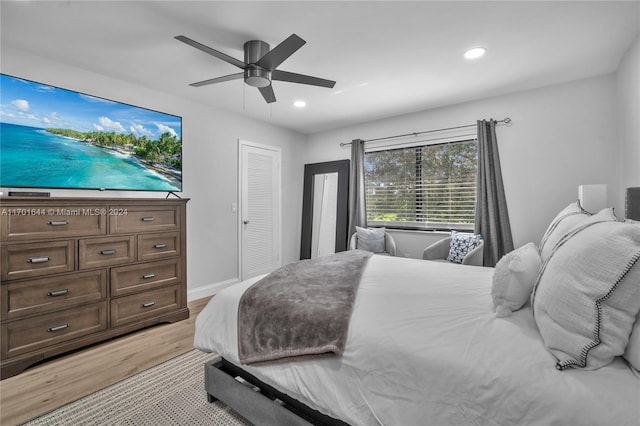 bedroom with ceiling fan and light hardwood / wood-style floors