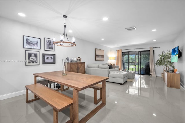 dining room with a chandelier and light tile patterned flooring