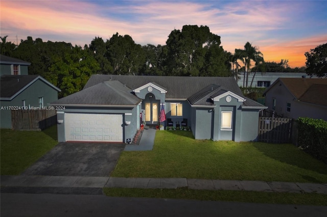 ranch-style house with a lawn and a garage