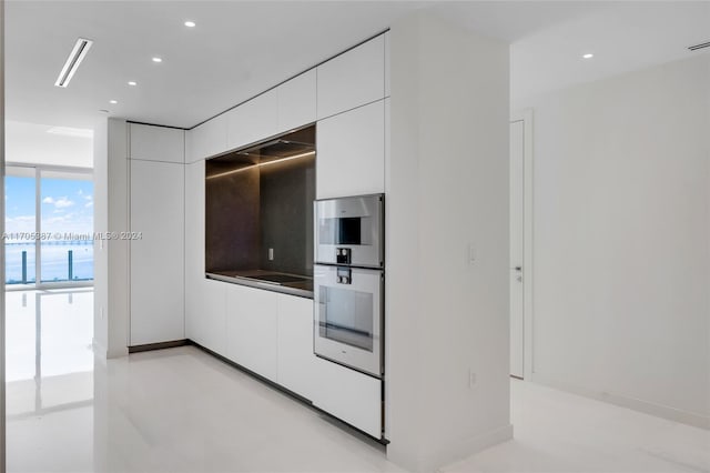 kitchen with a water view, white cabinetry, and stainless steel appliances