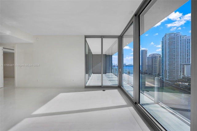 unfurnished room featuring expansive windows