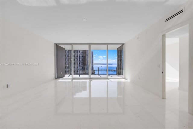 unfurnished room with expansive windows