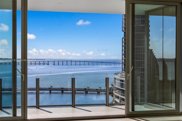 balcony with a water view and central air condition unit