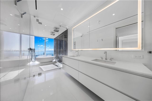 bathroom featuring vanity and shower with separate bathtub