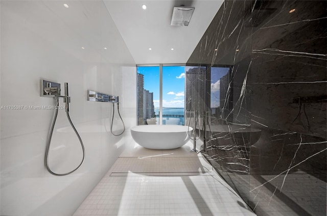 bathroom with floor to ceiling windows, tile patterned flooring, and independent shower and bath