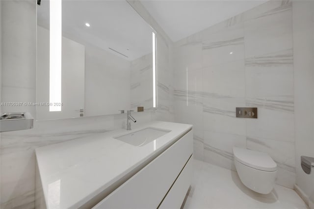 bathroom featuring vanity, toilet, and tile walls