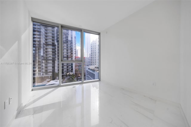 spare room with floor to ceiling windows