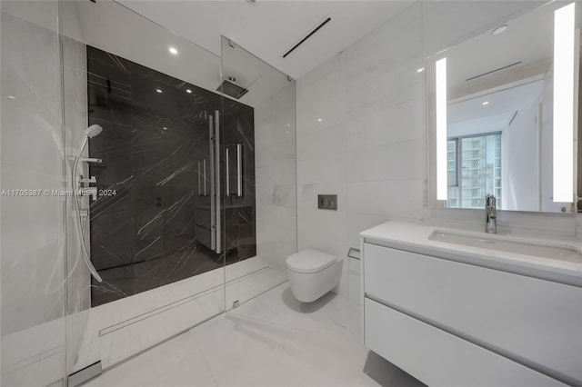 bathroom with tiled shower, vanity, toilet, and tile walls