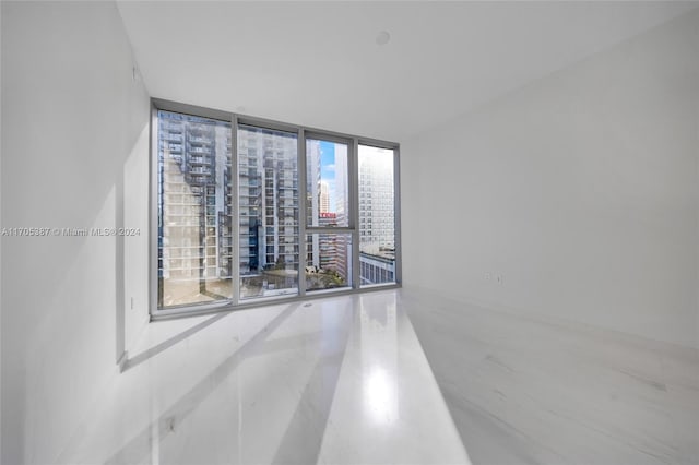 empty room with a wall of windows and plenty of natural light