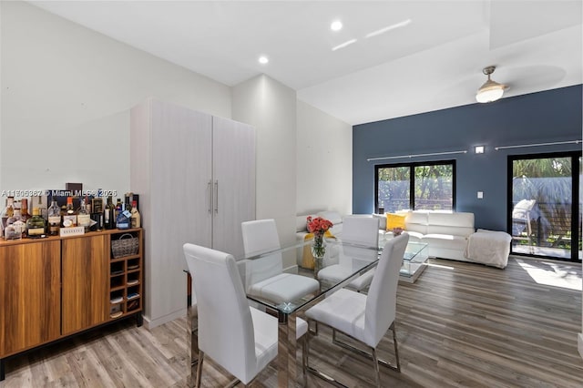 dining room featuring hardwood / wood-style flooring and bar