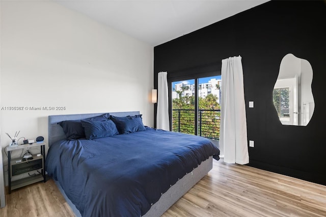 bedroom featuring access to outside and light hardwood / wood-style floors