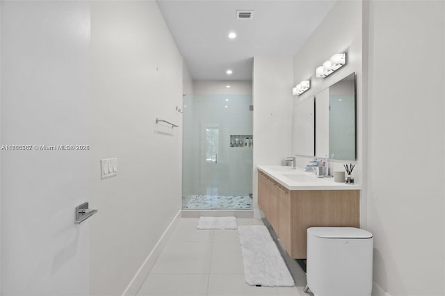 bathroom featuring toilet, tile patterned floors, a shower with shower door, and vanity