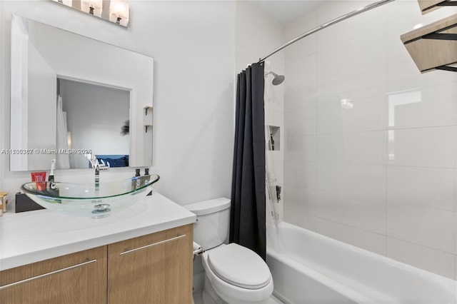 full bathroom featuring toilet, shower / bath combo, and vanity