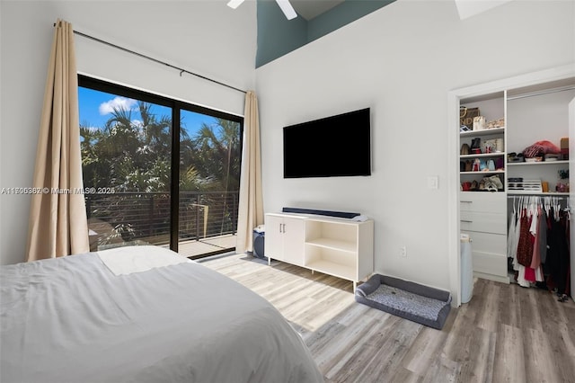 bedroom featuring ceiling fan, access to exterior, and light hardwood / wood-style floors