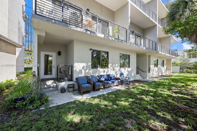 rear view of property with a lawn and an outdoor hangout area