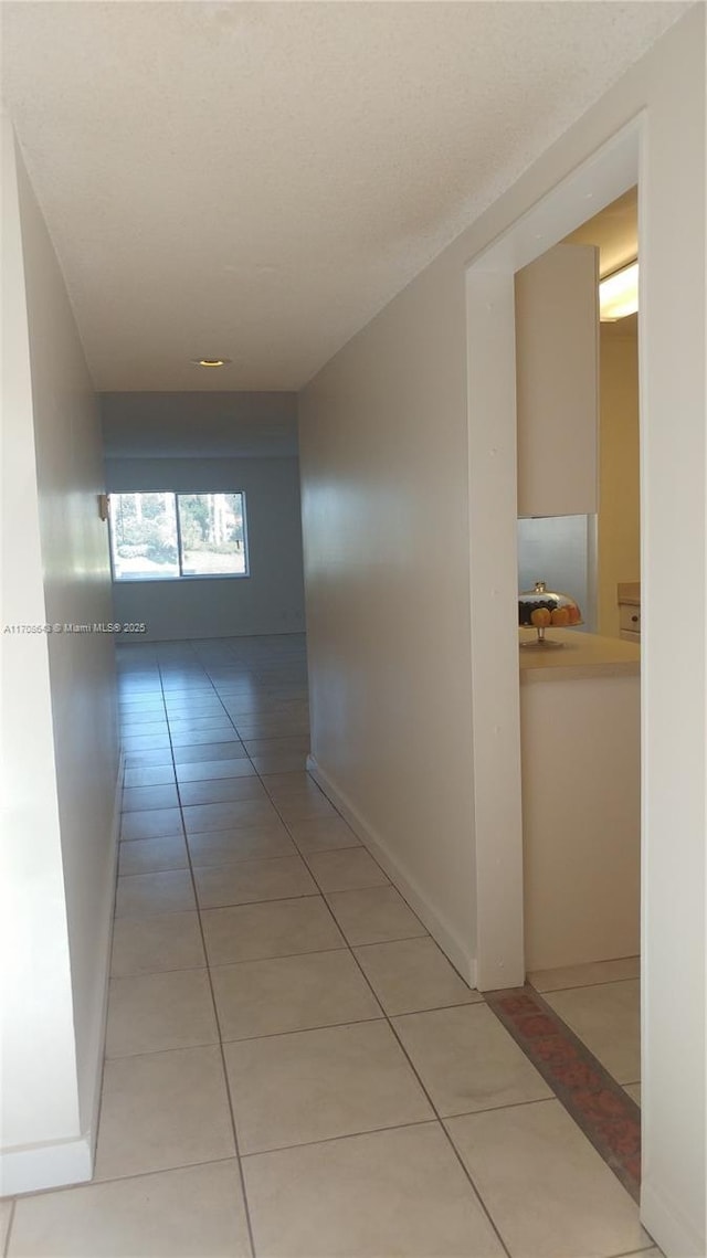 hall featuring light tile patterned flooring