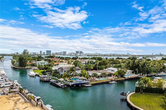 birds eye view of property featuring a water view and a city view