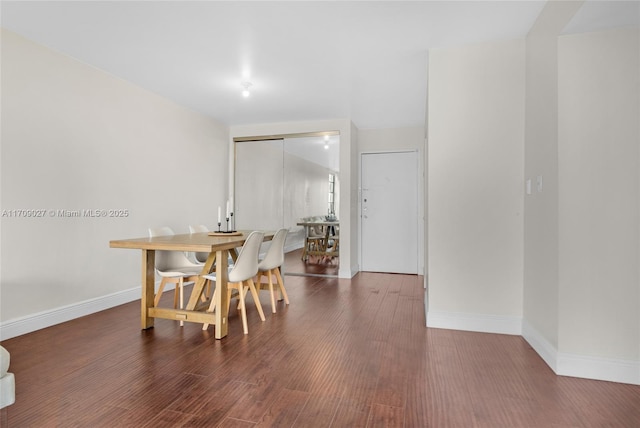 dining area with baseboards and wood finished floors