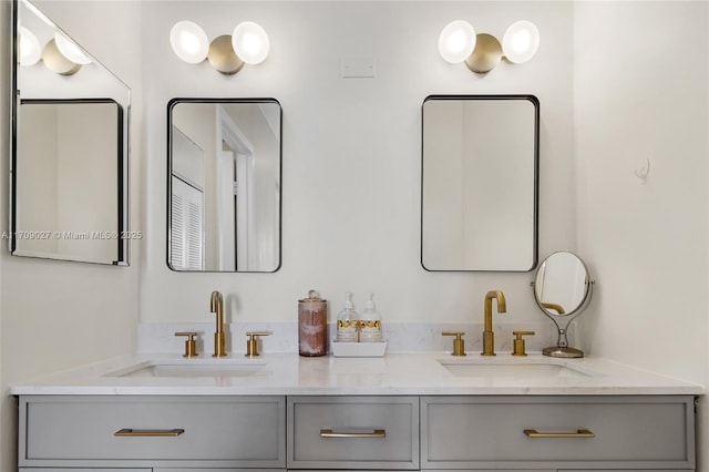 full bathroom featuring double vanity and a sink