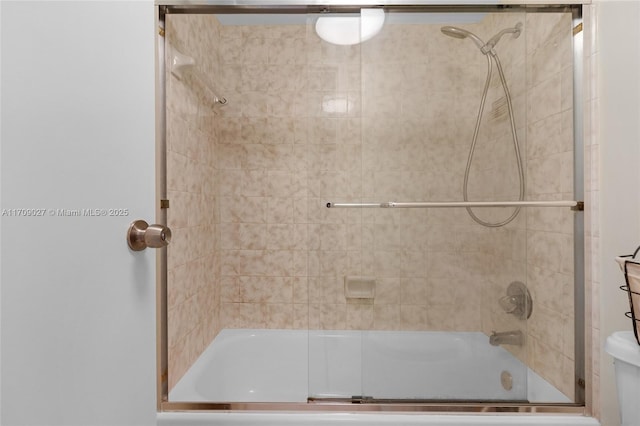 full bath with combined bath / shower with glass door and toilet