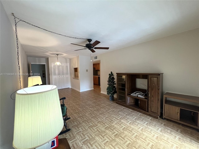 living room featuring light parquet flooring and ceiling fan